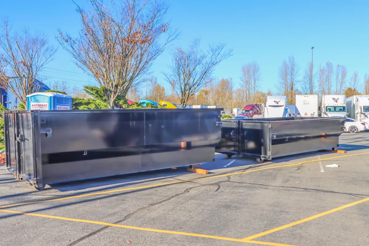 Professional dumpster rental service with roll-off container on residential driveway in Becker